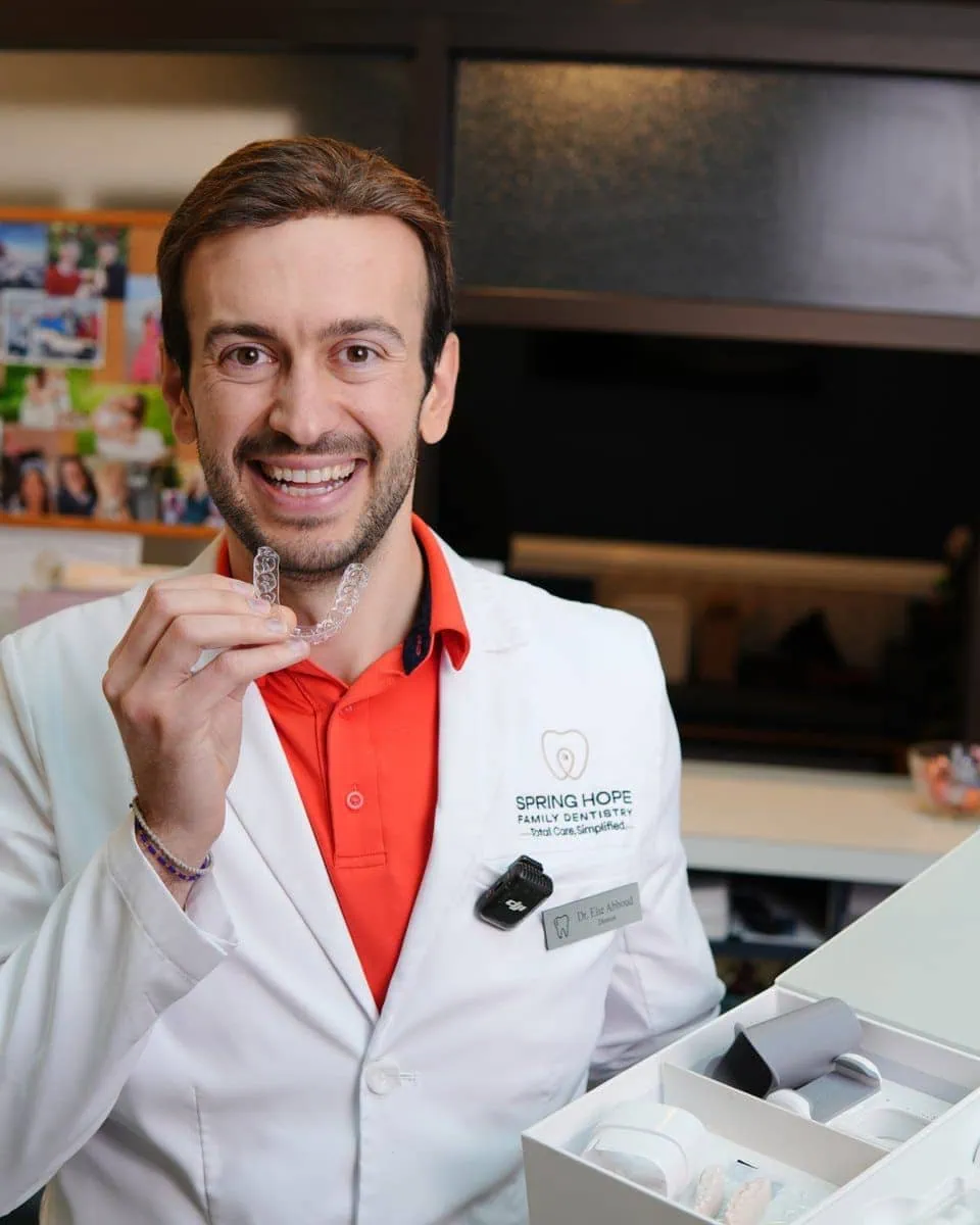 Dentist holding up a CandidPro clear aligner tray
