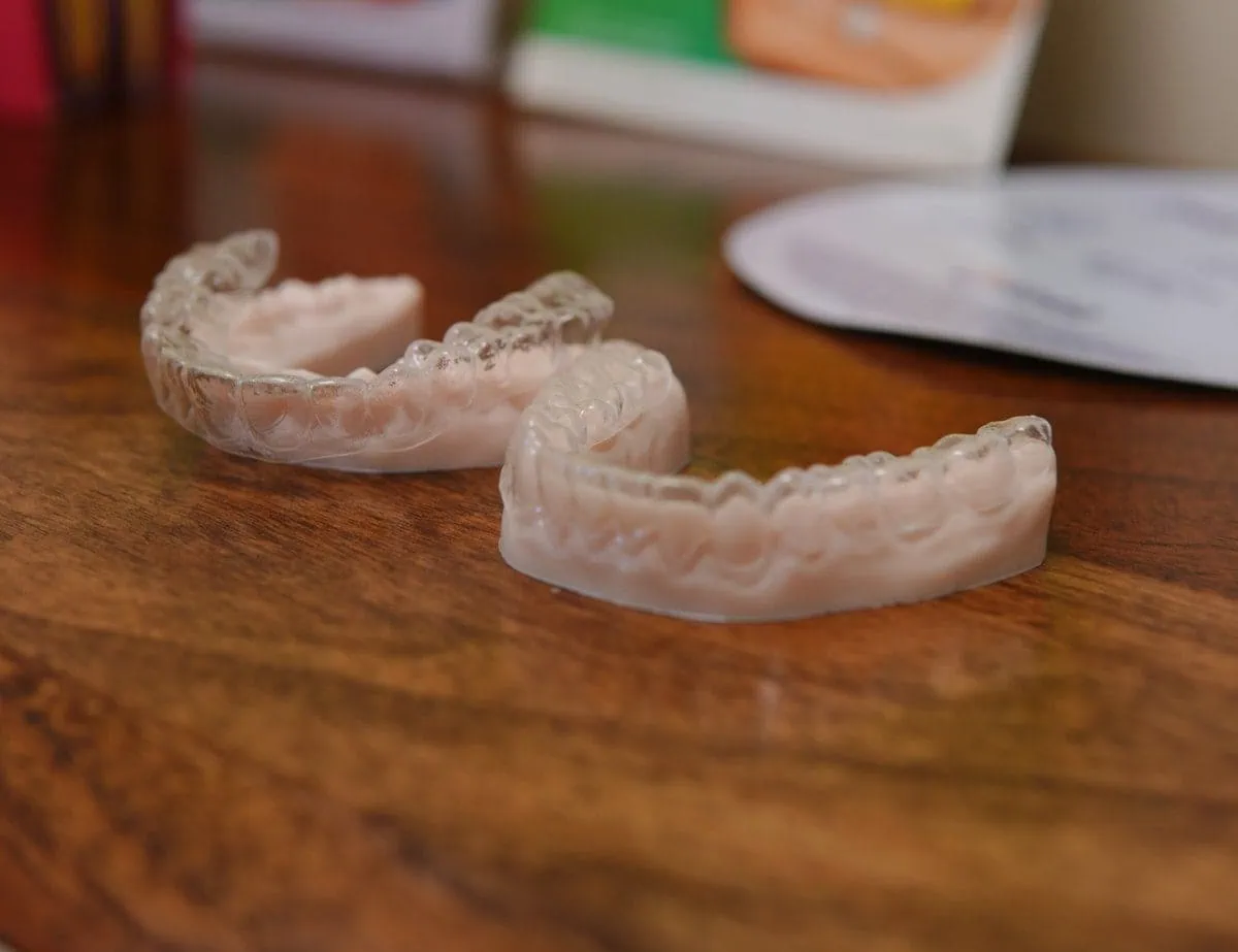 Upper and lower clear aligner trays on a table