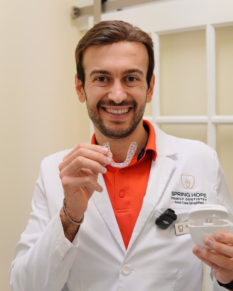 Dr. Elie Abboud holding CandidPro clear aligners at Spring Hope Family Dentistry