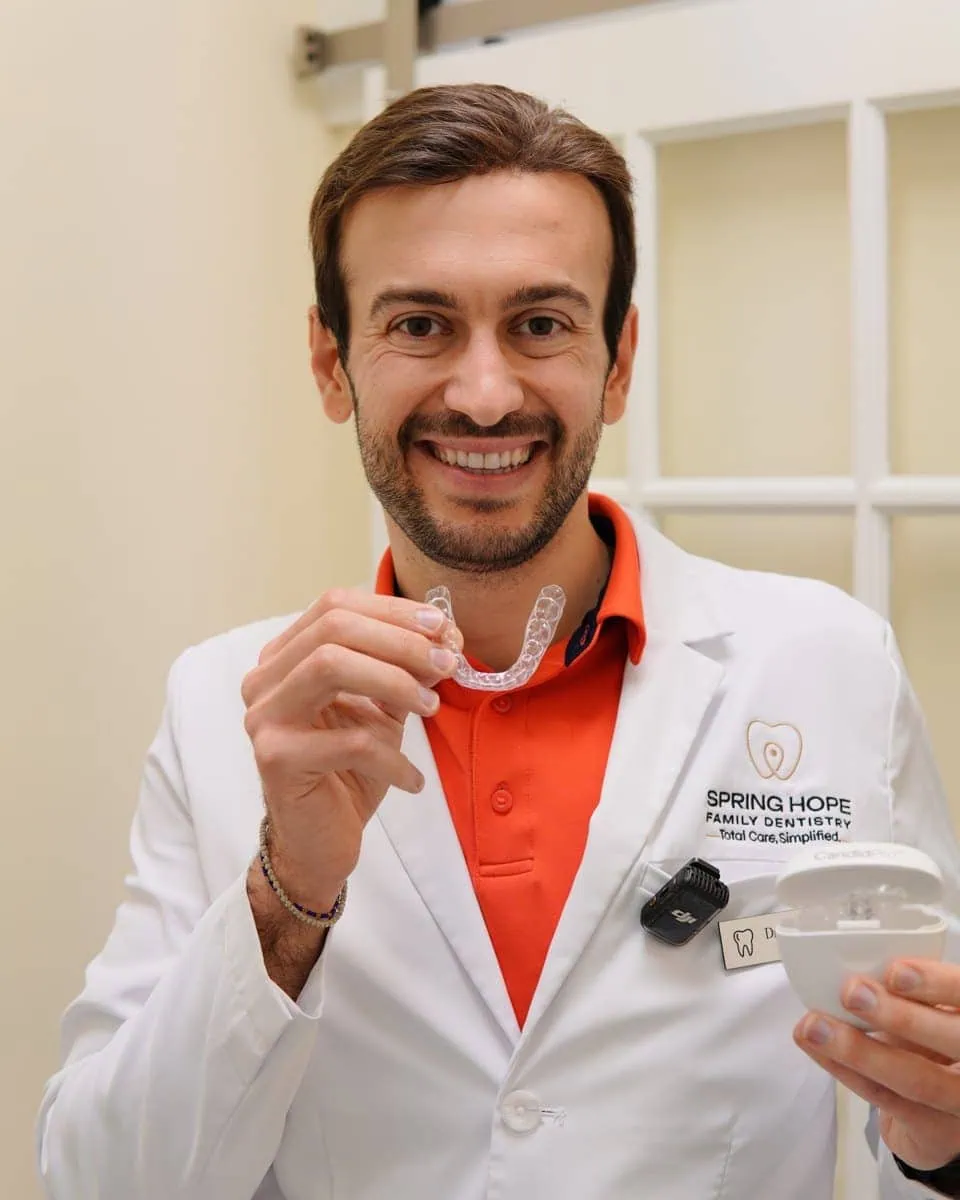 Dr. Elie Abboud holding CandidPro clear aligners at Spring Hope Family Dentistry