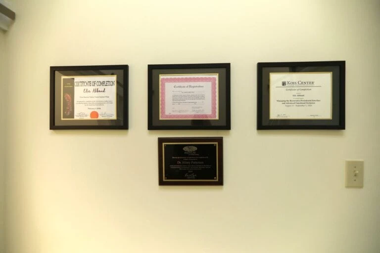 Continuing education certificates on the office wall, including the Kois Center