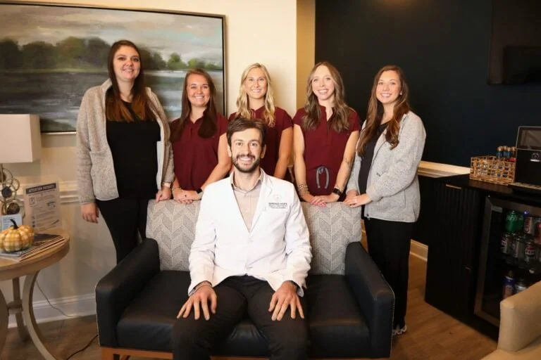 Dr. Elie Abboud seated with members of the Spring Hope Family Dentistry team in the office lounge