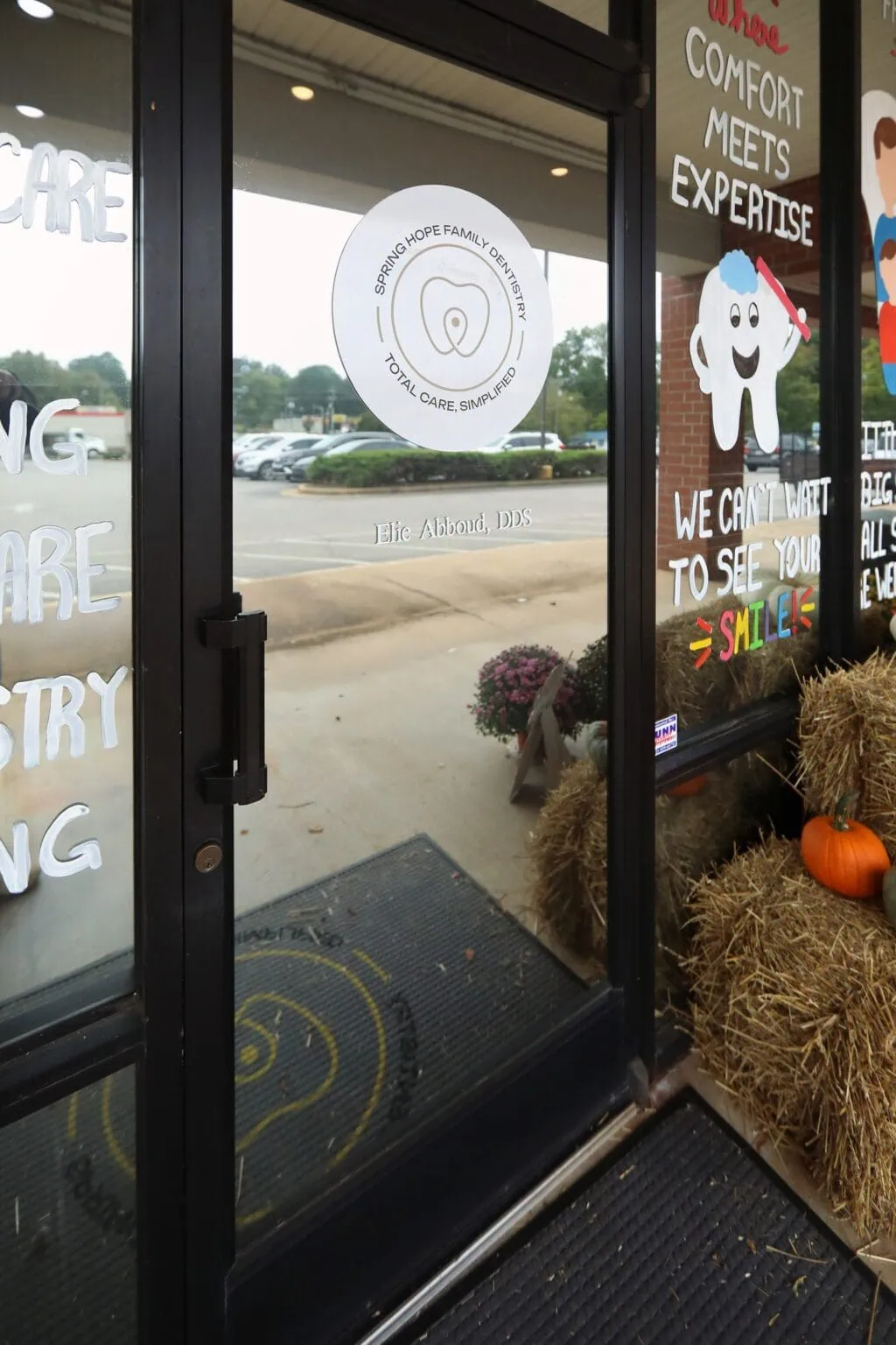 Front door of Spring Hope Family Dentistry with our logo on the glass