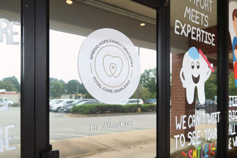 Front door of Spring Hope Family Dentistry at 615 E Nash St in Spring Hope, NC, with our logo on the glass